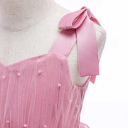 Pink dress with a bow on a mannequin against a white background