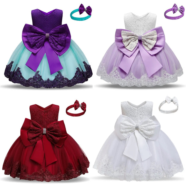 Four children's dresses with large bows and matching headbands on a white background