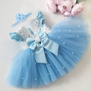 Light blue dress with bow and headband on a light background