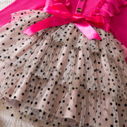 Polka dot dress with a pink bow on a pink background
