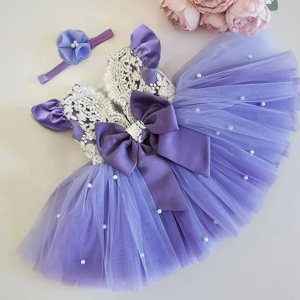 Purple tutu dress with silver headband and flowers on a light background
