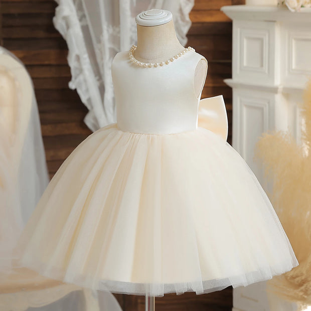 White tulle dress on a mannequin with a decorative background