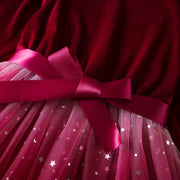 Close-up of a red dress with a pink bow and star pattern