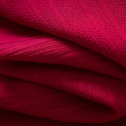Close-up of red fabric with a textured pattern