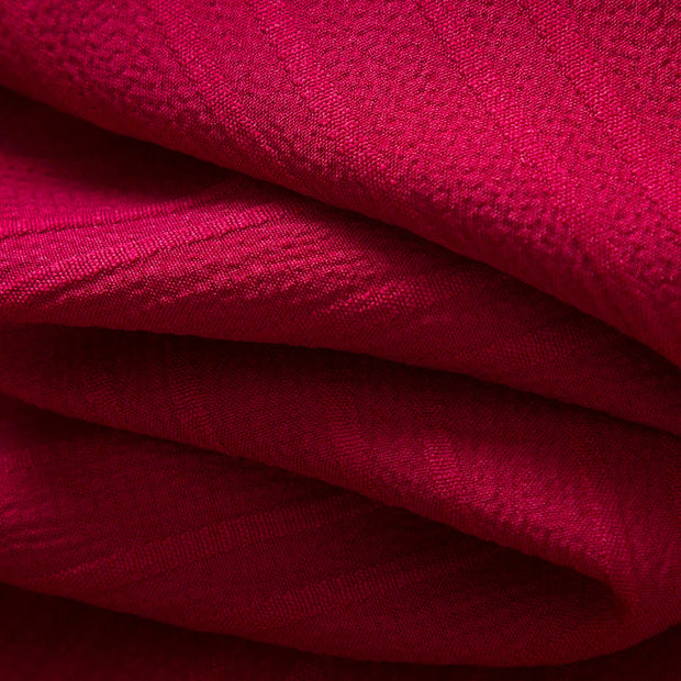 Close-up of red fabric with a textured pattern