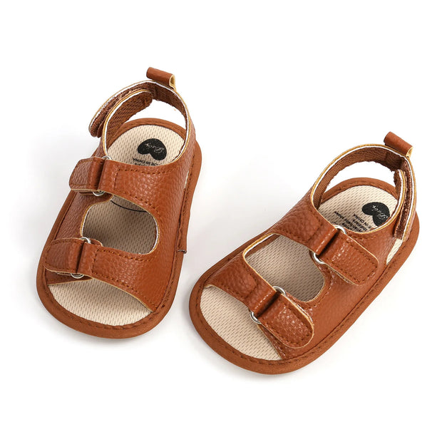 Pair of brown baby sandals on a white background