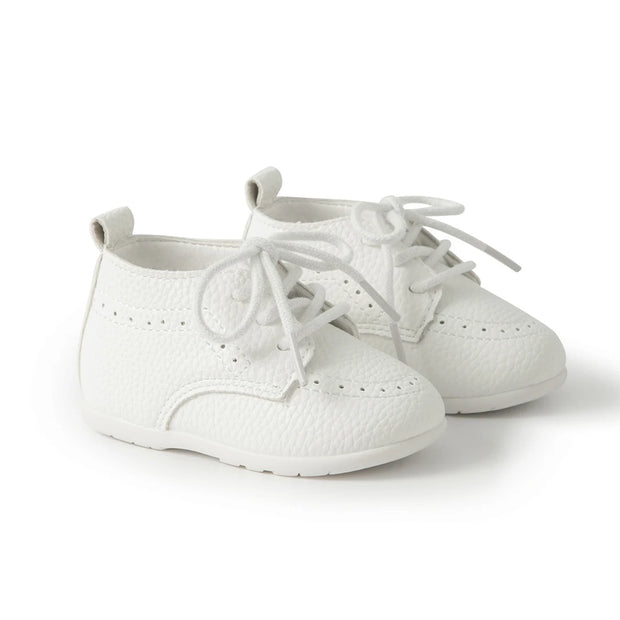 Pair of white baby shoes on a white background