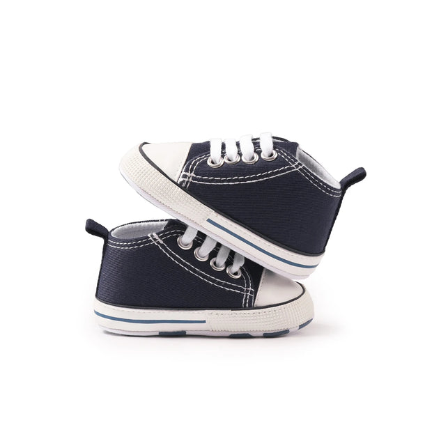 Pair of navy blue high-top sneakers with white soles on a white background