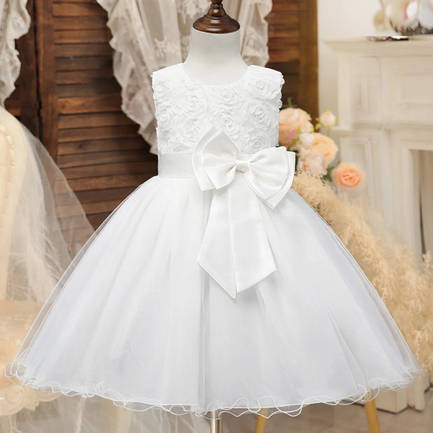 White lace dress with a large bow on a mannequin against a neutral background