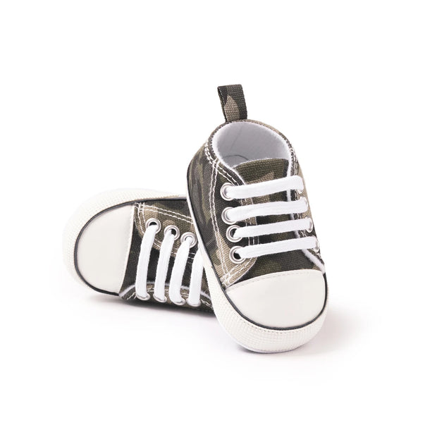 Pair of baby sneakers with white laces on a white background