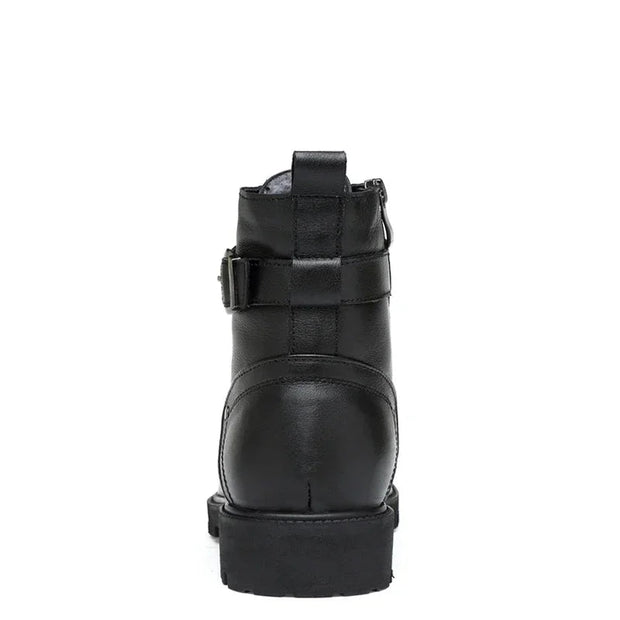 Black leather boot with a buckle on a white background