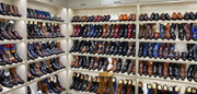 Shelving unit with a variety of boots in different colors and styles.