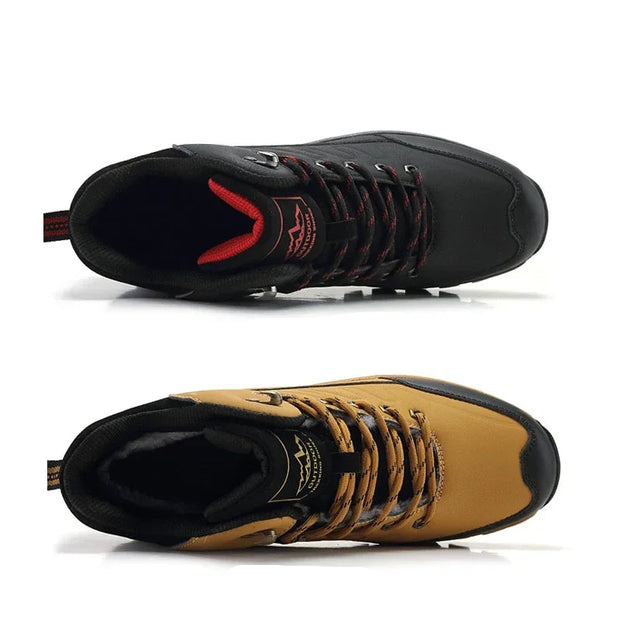 Black and tan boots with red accents on a white background