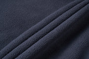 Close-up of dark blue textured fabric with folds
