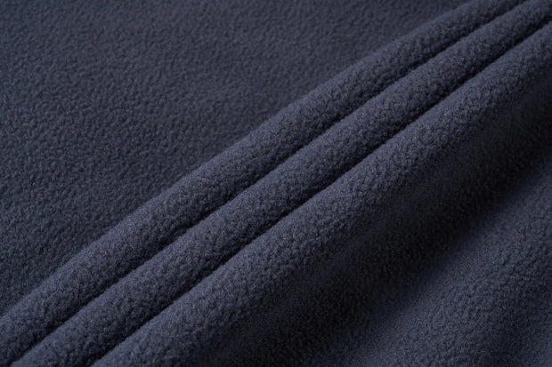 Close-up of dark blue textured fabric with folds