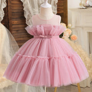 Pink tulle dress on a mannequin with a soft, blurred background