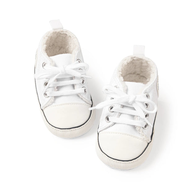 Pair of white baby sneakers on a white background