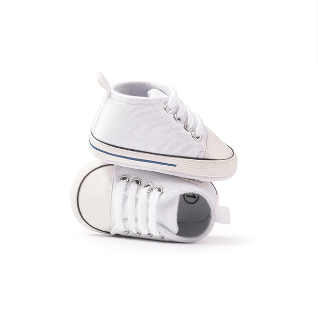 Pair of white sneakers on a white background