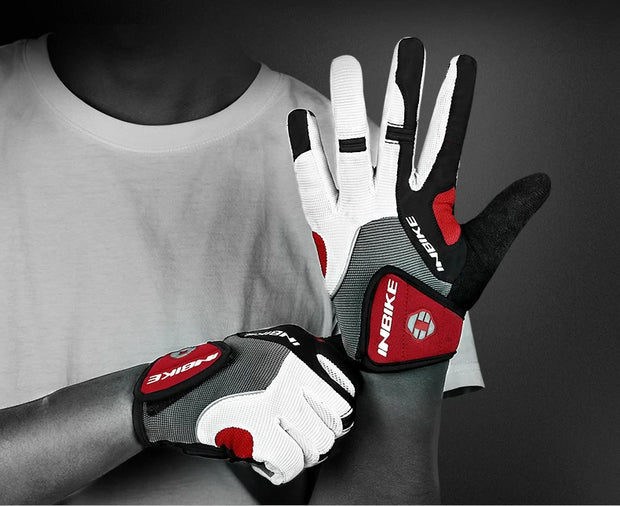 Person wearing red and black gloves on a dark background