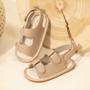 Pair of beige sandals on a light background