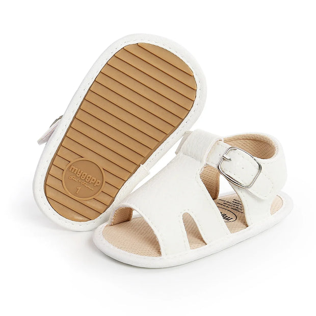 White sandal with brown sole on a white background