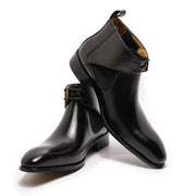 Black shiny boots with a strap on a white background