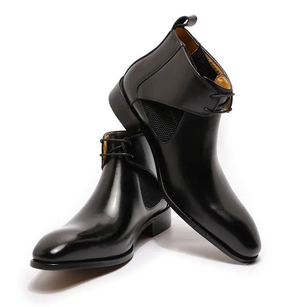 Black shiny boots with a strap on a white background