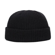 Black knit beanie on a white background