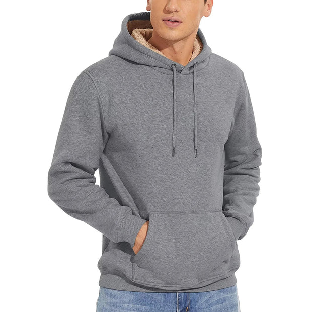 Person wearing a gray hoodie with a brand logo in the corner