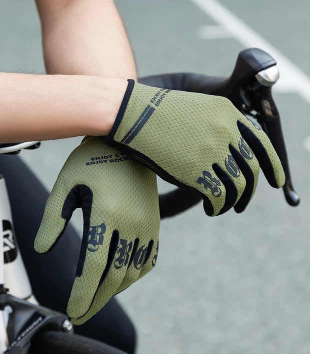 Person wearing green cycling gloves on a bicycle with a blurred background
