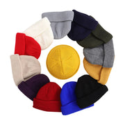 Collection of colorful knit beanies arranged in a circular pattern on a white background.