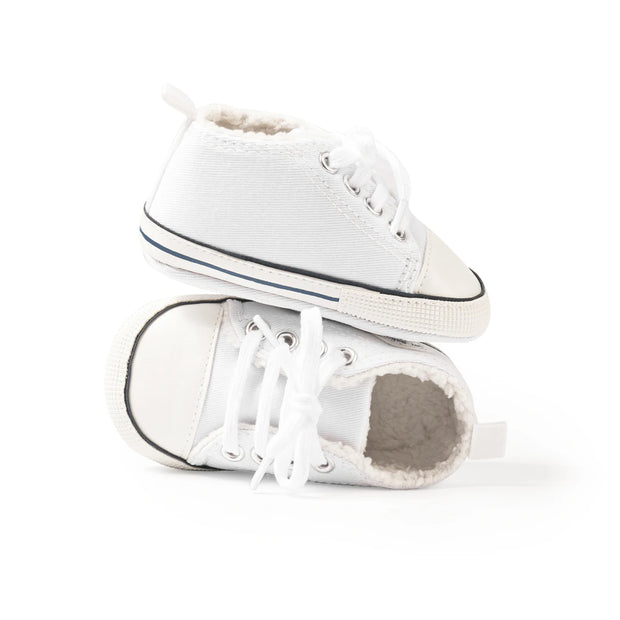White sneakers with a worn-out sole on a white background