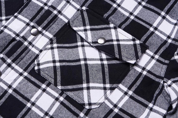 Close-up of a black and white plaid shirt with buttons.