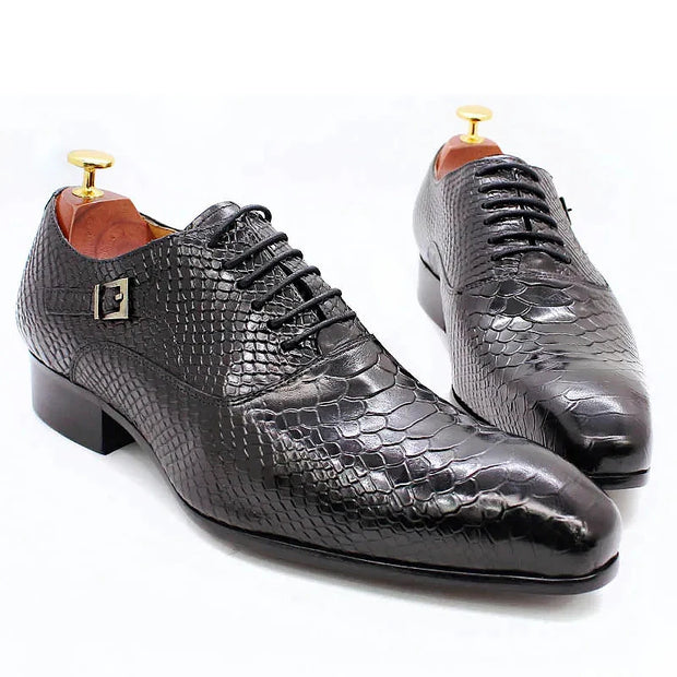 Pair of black textured dress shoes on a white background