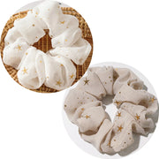 Set of white and beige scrunchies with star patterns on a white background