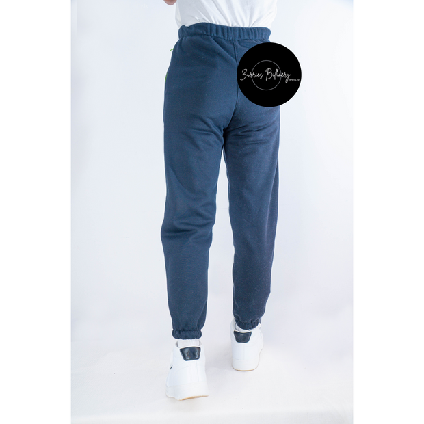 Blue sweatpants worn by a person on a white background with a brand logo.