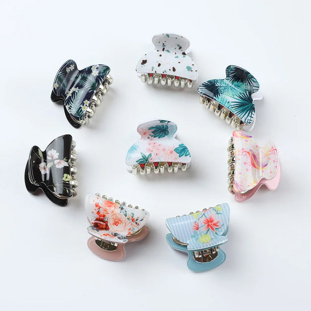 Set of colorful floral hair clips on a white background