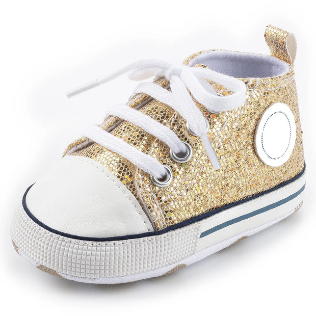 Gold glitter sneaker with white laces on a white background