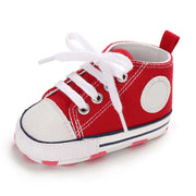 Red and white baby shoe on a white background