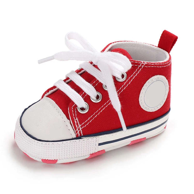 Red and white baby shoe on a white background