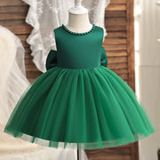 Green dress on a mannequin against a neutral background