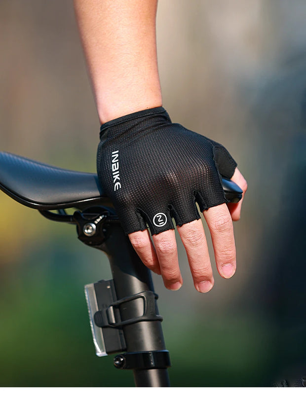 Person wearing a black cycling glove on a blurred background