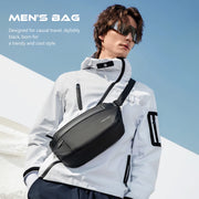 Man wearing a black crossbody bag with a clear blue sky background