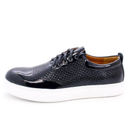 Black sneaker with white sole on a white background