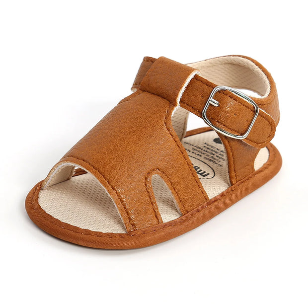 Brown sandal with a buckle on a white background