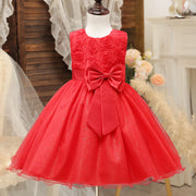 Red dress with a large bow on a mannequin against a decorative background