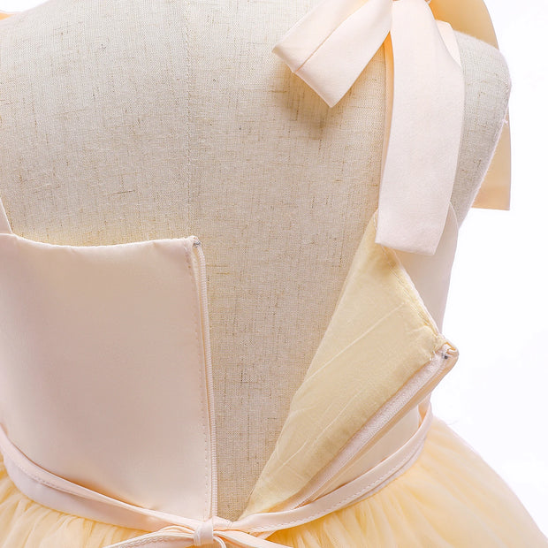 Mannequin wearing a light yellow dress with a bow detail on a white background