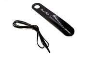 Black shoehorn with a cord on a white background