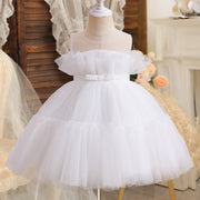 White tulle dress on a mannequin with a soft focus background