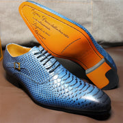 Blue and orange shoes with textured design on a brown surface